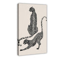 two spotted big cats in contrasting poses in black, warm cream tones — Wrapped Canvas HERO