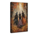 three witches walking through an autumn forest in orange, black, purple tones — Wrapped Canvas HERO